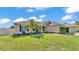 Beautiful single-story home featuring lush landscaping, a well-manicured lawn, and a welcoming front entrance at 555 Heather Glen Dr, Winter Haven, FL 33884