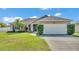 Charming single-story home with a well-manicured lawn and attached two-car garage at 555 Heather Glen Dr, Winter Haven, FL 33884