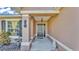 Inviting front porch with decorative pineapple, bird bath, and lush landscaping at 555 Heather Glen Dr, Winter Haven, FL 33884