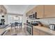 Modern kitchen with stainless steel appliances and a breakfast bar area at 555 Heather Glen Dr, Winter Haven, FL 33884