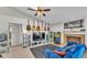 Cozy living room with fireplace, guitars on the wall, and a blue sofa at 555 Heather Glen Dr, Winter Haven, FL 33884