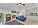 Comfortable living room with a fireplace, aquarium and view into dining area at 555 Heather Glen Dr, Winter Haven, FL 33884