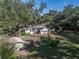 Aerial view of the home and detached storage shed, set among mature trees and a well-maintained lawn at 5624 Laurel Oak Dr, Lakeland, FL 33811
