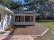 Backyard patio featuring a brick surface ideal for outdoor dining and entertainment under mature trees at 5624 Laurel Oak Dr, Lakeland, FL 33811