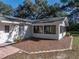 Brick patio that highlights the outdoor space, perfect for entertaining, set against lush greenery at 5624 Laurel Oak Dr, Lakeland, FL 33811