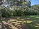 Expansive backyard surrounded by mature trees providing shade and natural beauty at 5624 Laurel Oak Dr, Lakeland, FL 33811