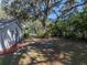 Backyard landscape with a bird bath, lush foliage, and mature trees offer a serene retreat at 5624 Laurel Oak Dr, Lakeland, FL 33811