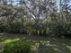 Overgrown foliage borders the verdant yard, offering privacy from neighbors at 5624 Laurel Oak Dr, Lakeland, FL 33811