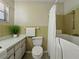 Clean bathroom featuring a walk-in bathtub with a shower and a toilet at 5624 Laurel Oak Dr, Lakeland, FL 33811