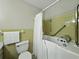 Bright bathroom featuring a walk-in bathtub with white shower curtain and grab bar at 5624 Laurel Oak Dr, Lakeland, FL 33811