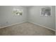 Cozy bedroom with carpeted floor and two windows providing natural light at 5624 Laurel Oak Dr, Lakeland, FL 33811