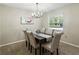 Elegant dining room featuring a modern chandelier and seating for six guests at 5624 Laurel Oak Dr, Lakeland, FL 33811