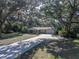Aerial view of a lovely home with mature landscaping, a long driveway, and a garage, all nestled among shady trees at 5624 Laurel Oak Dr, Lakeland, FL 33811