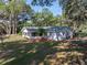 Well-maintained home with a spacious lawn and mature trees create a serene and inviting atmosphere at 5624 Laurel Oak Dr, Lakeland, FL 33811