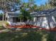 Exterior view with updated landscaping and fresh mulch accents the home's curb appeal at 5624 Laurel Oak Dr, Lakeland, FL 33811