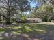 Charming single-story brick home featuring a well-manicured lawn and mature trees, creating a serene and inviting curb appeal at 5624 Laurel Oak Dr, Lakeland, FL 33811
