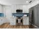 Kitchen featuring stainless steel appliances, white cabinetry and blue subway tile backsplash at 5624 Laurel Oak Dr, Lakeland, FL 33811
