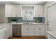 Well-lit kitchen features stainless steel dishwasher, undermount sink and blue backsplash at 5624 Laurel Oak Dr, Lakeland, FL 33811