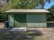 Close-up of a backyard outbuilding with a metal roof and double doors at 5624 Laurel Oak Dr, Lakeland, FL 33811