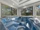 Close up of the in-door spa highlighting the jets and seating, surrounded by large windows at 5624 Laurel Oak Dr, Lakeland, FL 33811