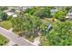 Aerial view of home surrounded by mature trees, set back from the road with a palm tree in the front yard at 5751 Cherry Tree Dr, Lakeland, FL 33811