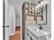 Bathroom with rustic accent shelving, white vanity and updated fixtures at 5751 Cherry Tree Dr, Lakeland, FL 33811