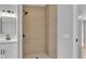 Modern bathroom boasts a glass enclosed shower with pebble floor and updated fixtures at 5751 Cherry Tree Dr, Lakeland, FL 33811