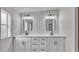 Bathroom featuring double sinks with modern fixtures and a large window providing natural light at 5751 Cherry Tree Dr, Lakeland, FL 33811