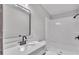 Bathroom with white vanity, updated fixtures, and shower-tub combo at 5751 Cherry Tree Dr, Lakeland, FL 33811