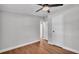 This bedroom features a ceiling fan, wood-look floors, neutral paint, and an entrance to another room at 5751 Cherry Tree Dr, Lakeland, FL 33811
