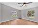 This bedroom boasts laminate floors, two windows that bring in tons of natural light, and neutral paint at 5751 Cherry Tree Dr, Lakeland, FL 33811