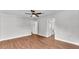Large bedroom featuring wood-look vinyl floors, ceiling fan, and attached bathroom at 5751 Cherry Tree Dr, Lakeland, FL 33811