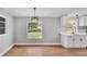 Dining area featuring a contemporary light fixture, vinyl flooring, and large windows at 5751 Cherry Tree Dr, Lakeland, FL 33811