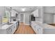 Bright kitchen featuring white cabinets, stainless steel appliances, and a functional layout, designed for modern living at 5751 Cherry Tree Dr, Lakeland, FL 33811
