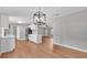 Open-concept kitchen with island, modern pendant lighting, and stainless steel appliances at 5751 Cherry Tree Dr, Lakeland, FL 33811