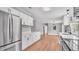 Modern kitchen featuring stainless steel appliances, white cabinets, and wood-look vinyl floors at 5751 Cherry Tree Dr, Lakeland, FL 33811