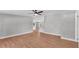 Spacious living room with modern wood floors, neutral paint, and a ceiling fan, leading into the rest of the home at 5751 Cherry Tree Dr, Lakeland, FL 33811