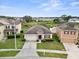 An aerial view showcases this property and neighboring homes, with lush greenery and blue skies at 5793 Dornich Dr, Auburndale, FL 33823