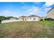 The large backyard has a fence, grass, and views of other neighborhood homes at 5793 Dornich Dr, Auburndale, FL 33823