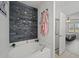 Bathroom featuring soaking tub, wood accent wall, and separate shower at 5793 Dornich Dr, Auburndale, FL 33823