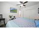 Bedroom with a ceiling fan and a TV; also features a view into the doorway at 5793 Dornich Dr, Auburndale, FL 33823