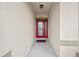 Inviting front entrance featuring a red door and sheltered entryway at 5793 Dornich Dr, Auburndale, FL 33823