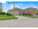 Inviting home with manicured lawn, stone facade, two-car garage, and sidewalk access at 5793 Dornich Dr, Auburndale, FL 33823