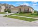 Attractive home boasts a well-kept lawn, stone accents, and an attached two-car garage at 5793 Dornich Dr, Auburndale, FL 33823