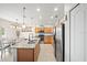 The kitchen has stainless steel appliances and granite countertops next to the dining area at 5793 Dornich Dr, Auburndale, FL 33823