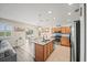 Modern kitchen featuring stainless steel appliances, granite countertops, and a center island open to the dining area at 5793 Dornich Dr, Auburndale, FL 33823
