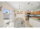 The kitchen opens to the dining area with stainless steel appliances, granite countertops, and a dining table at 5793 Dornich Dr, Auburndale, FL 33823