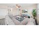 Comfortable living room features a large gray sectional, ceiling fan, and modern decor at 5793 Dornich Dr, Auburndale, FL 33823