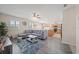 Comfortable living room and open kitchen features a large gray sectional, ceiling fan, and modern decor at 5793 Dornich Dr, Auburndale, FL 33823