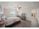 Comfortable main bedroom featuring wood-look floors, a ceiling fan, and a desk area at 5793 Dornich Dr, Auburndale, FL 33823